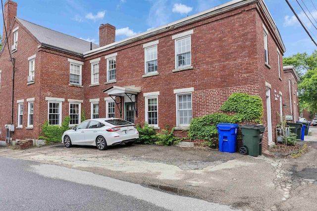 102 W Merrimack St Unit 1, Manchester, NH 03101 - view of front facade with a chimney and brick siding