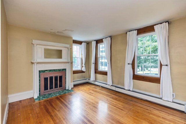 102 W Merrimack St Unit 1, Manchester, NH 03101 - unfurnished living room featuring a fireplace with flush hearth, light wood finished floors, and baseboard heating