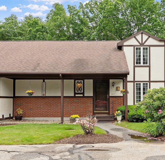 3 Chandler Dr, Atkinson, NH 03811 - view of front of house featuring brick siding, roof with shingles, a porch, and stucco siding