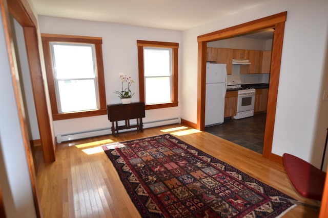 27 Randall St, Waterbury, VT 05676 - hall featuring a baseboard heating unit and dark wood finished floors