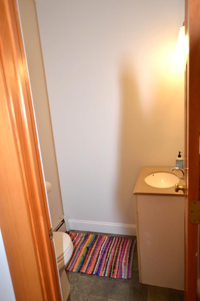 27 Randall St, Waterbury, VT 05676 - half bathroom with vanity and a baseboard radiator