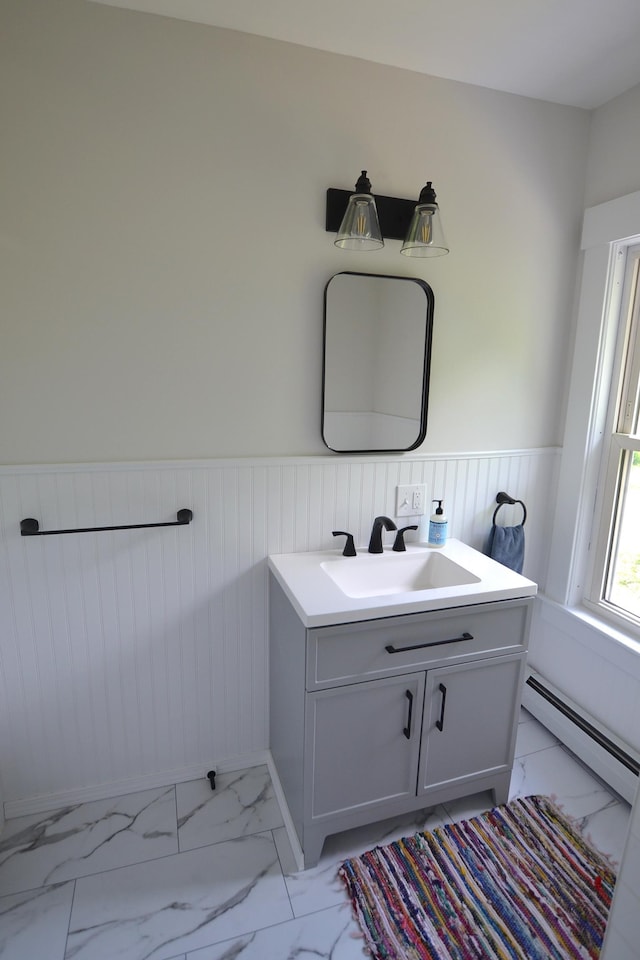 27 Randall St, Waterbury, VT 05676 - bathroom featuring baseboard heating, a wainscoted wall, marble look tiles, and vanity