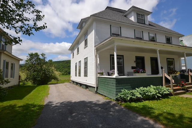 27 Randall St, Waterbury, VT 05676 - view of front of property featuring a porch, a front yard, driveway, and roof with shingles