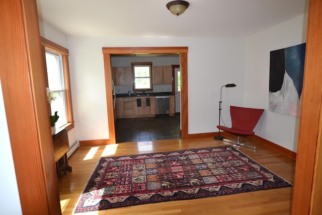 27 Randall St, Waterbury, VT 05676 - hall with wood finished floors and a baseboard heating unit