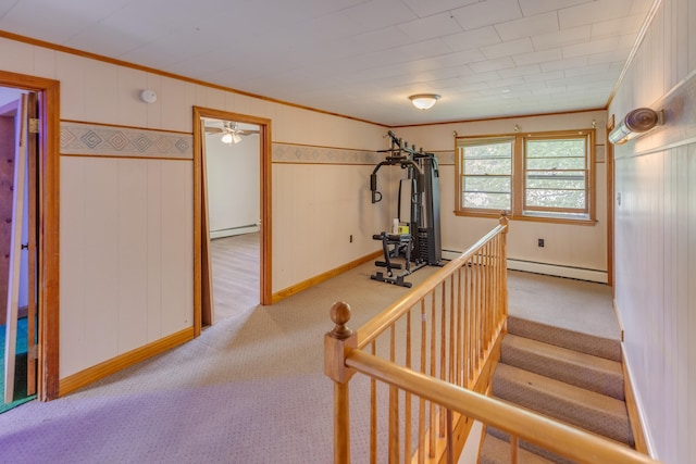 6 Goodbout Rd, Lincoln, NH 03251 - exercise area with ornamental molding, carpet floors, baseboard heating, a ceiling fan, and wood walls