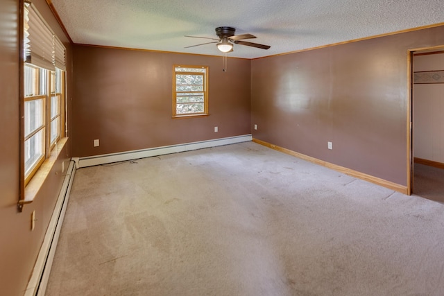 6 Goodbout Rd, Lincoln, NH 03251 - unfurnished room with a baseboard radiator, a textured ceiling, a ceiling fan, ornamental molding, and light colored carpet