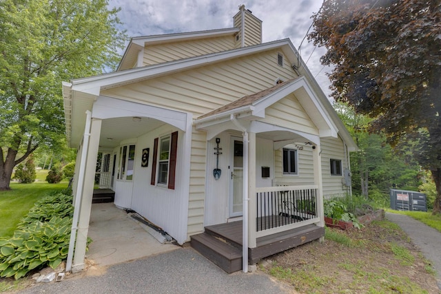 6 Goodbout Rd, Lincoln, NH 03251 - view of front facade with a chimney and covered porch