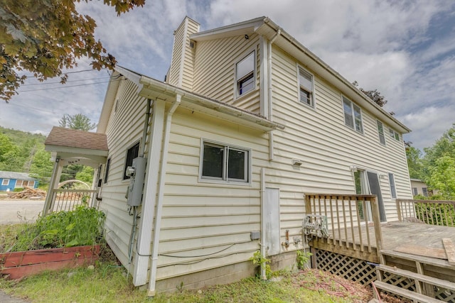 6 Goodbout Rd, Lincoln, NH 03251 - rear view of house featuring a wooden deck and a chimney