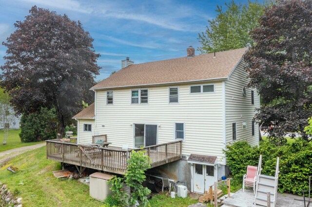 6 Goodbout Rd, Lincoln, NH 03251 - back of property featuring a wooden deck, a lawn, a chimney, and roof with shingles