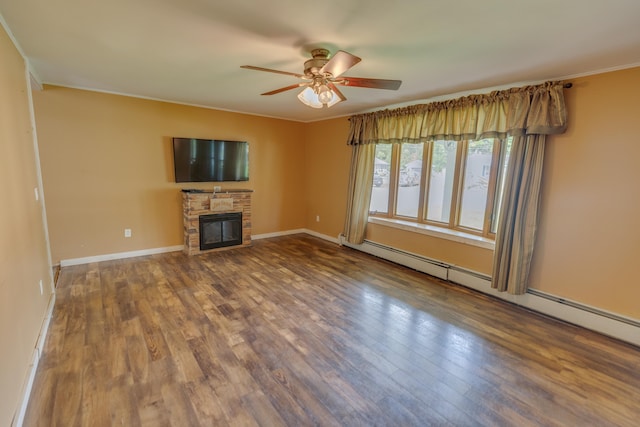 6 Goodbout Rd, Lincoln, NH 03251 - unfurnished living room with a baseboard heating unit, a ceiling fan, a fireplace, wood finished floors, and ornamental molding