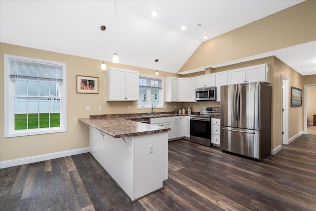 5 Rolling Hills Dr, Tilton, NH 03276 - kitchen featuring appliances with stainless steel finishes, a peninsula, white cabinets, dark countertops, and dark wood-style flooring