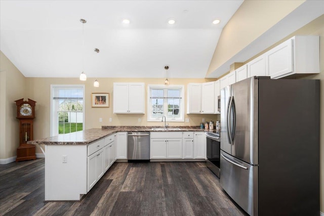 5 Rolling Hills Dr, Tilton, NH 03276 - kitchen with appliances with stainless steel finishes, vaulted ceiling, a peninsula, dark wood-type flooring, and white cabinetry