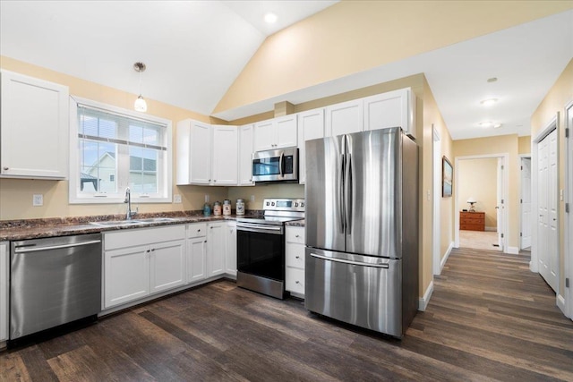 5 Rolling Hills Dr, Tilton, NH 03276 - kitchen featuring stainless steel appliances, dark wood-style flooring, white cabinetry, lofted ceiling, and hanging light fixtures