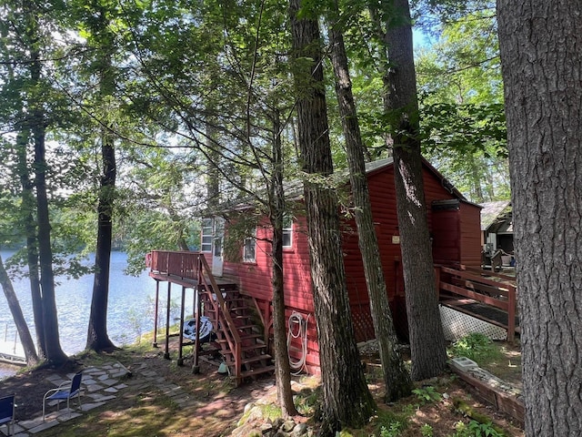 224 Nippo Ct, Barrington, NH 03825 - view of home's exterior with stairway and a deck with water view