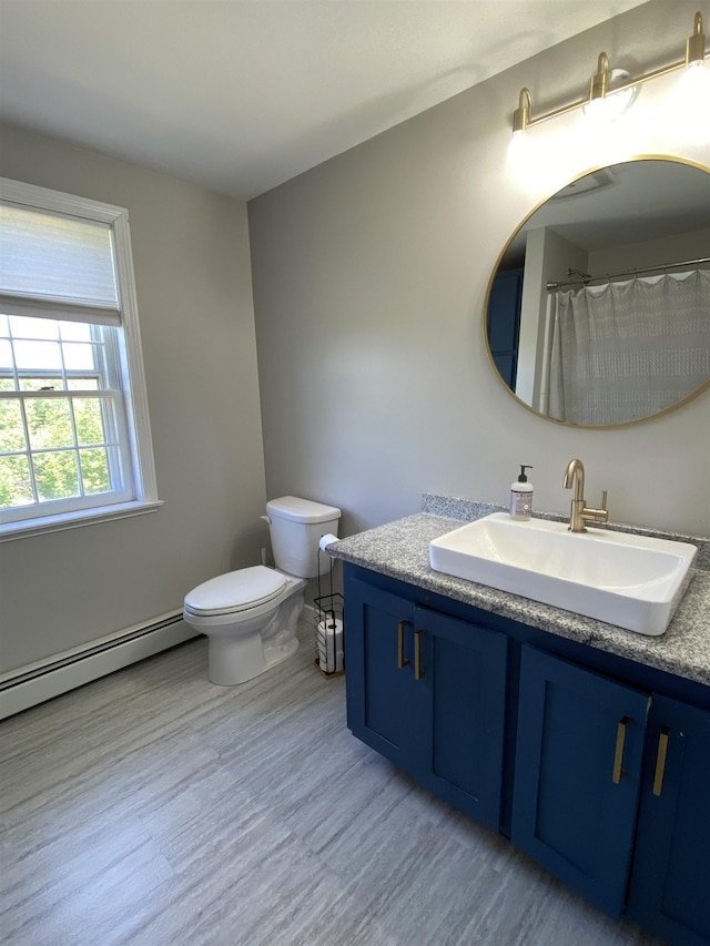 69 Emerson Hill Rd, New Ipswich, NH 03071 - full bath with a baseboard radiator, vanity, and wood finished floors