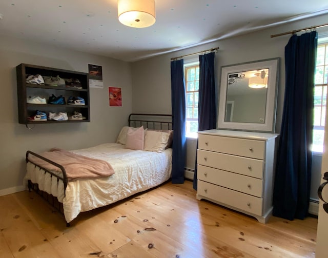 69 Emerson Hill Rd, New Ipswich, NH 03071 - bedroom with light wood finished floors and a baseboard heating unit