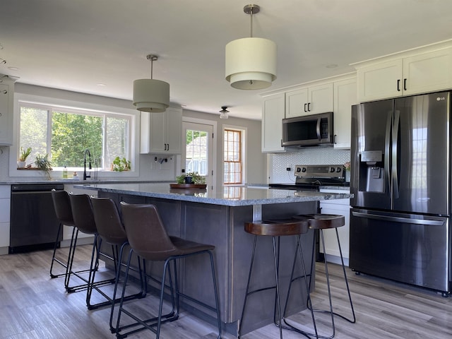 69 Emerson Hill Rd, New Ipswich, NH 03071 - kitchen with stainless steel appliances, backsplash, a center island, and light wood-style floors