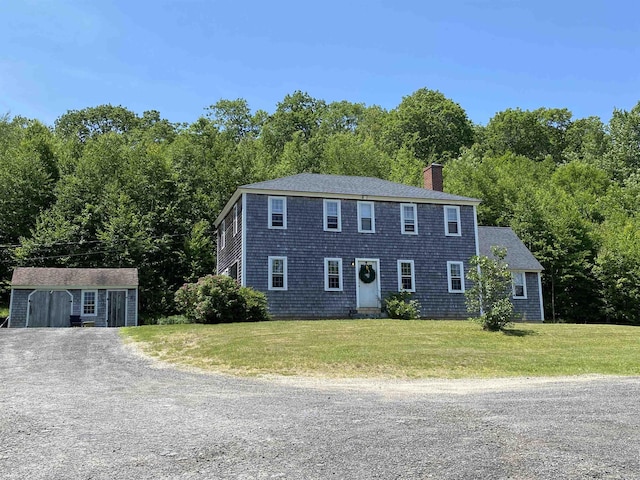 69 Emerson Hill Rd, New Ipswich, NH 03071 - colonial home with driveway, a chimney, a front lawn, and a forest view