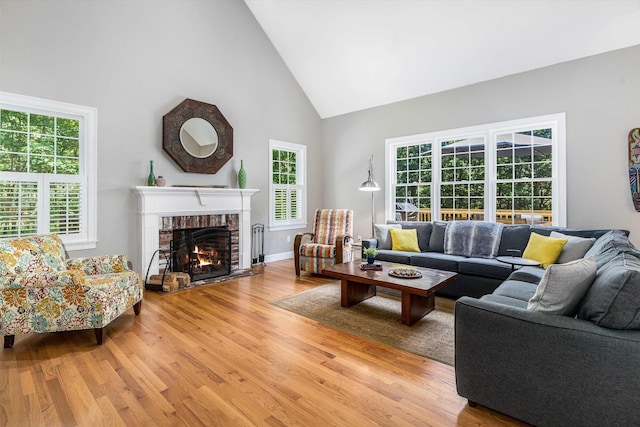 11 Mcafee Farm Rd, Bedford, NH 03110 - living room featuring high vaulted ceiling, light wood finished floors, plenty of natural light, and a fireplace