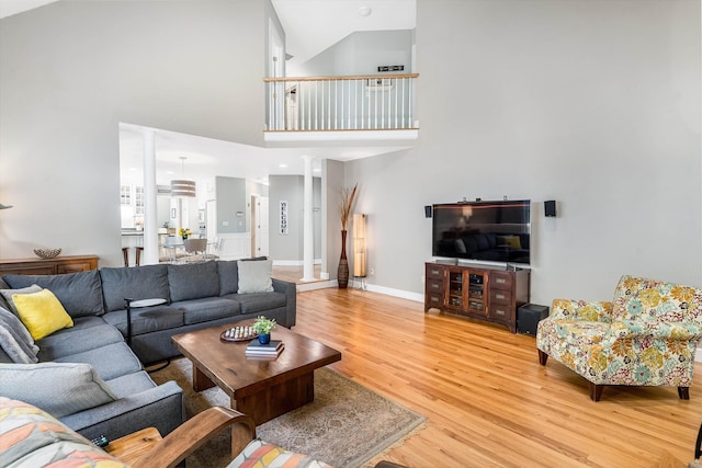 11 Mcafee Farm Rd, Bedford, NH 03110 - living room featuring light wood finished floors, decorative columns, and a high ceiling