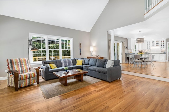 11 Mcafee Farm Rd, Bedford, NH 03110 - living area with high vaulted ceiling, light wood finished floors, and ornate columns