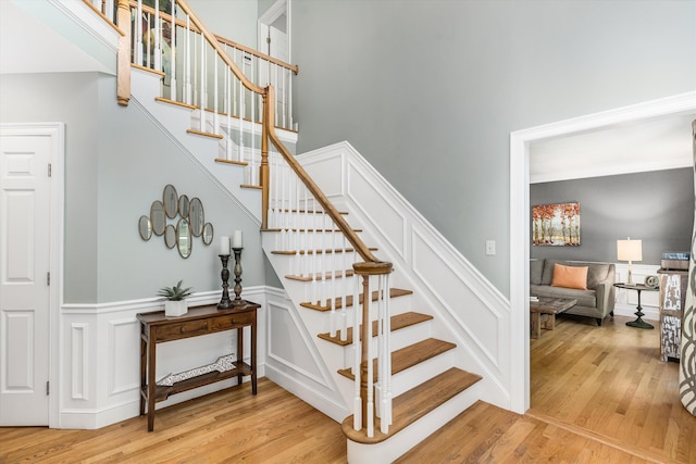 11 Mcafee Farm Rd, Bedford, NH 03110 - stairs featuring wood finished floors, a wainscoted wall, and a decorative wall