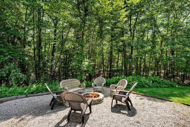 11 Mcafee Farm Rd, Bedford, NH 03110 - view of patio with an outdoor fire pit and a view of trees