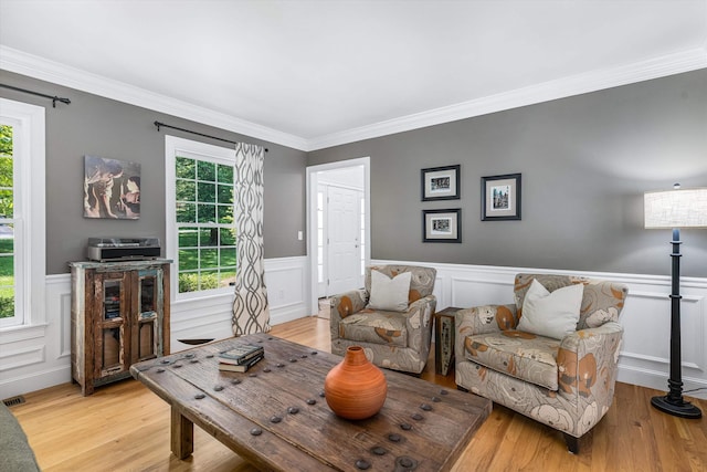 11 Mcafee Farm Rd, Bedford, NH 03110 - living area featuring plenty of natural light, wood finished floors, a wainscoted wall, and crown molding