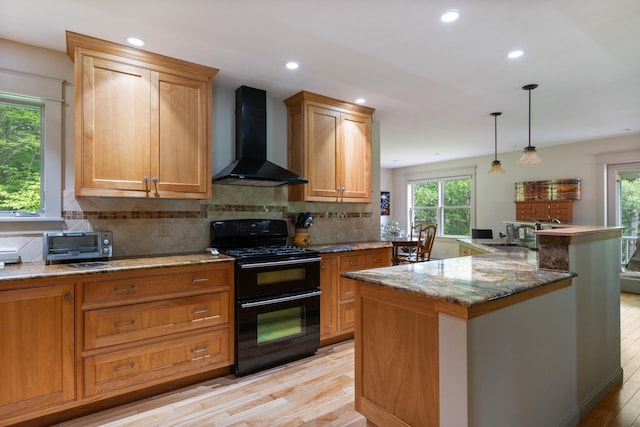 204 Mary Dr, Richmond, VT 05477 - kitchen featuring black range with gas stovetop, wall chimney range hood, light wood-type flooring, healthy amount of natural light, and recessed lighting