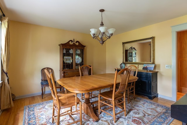 204 Mary Dr, Richmond, VT 05477 - dining space featuring a chandelier and light wood-type flooring