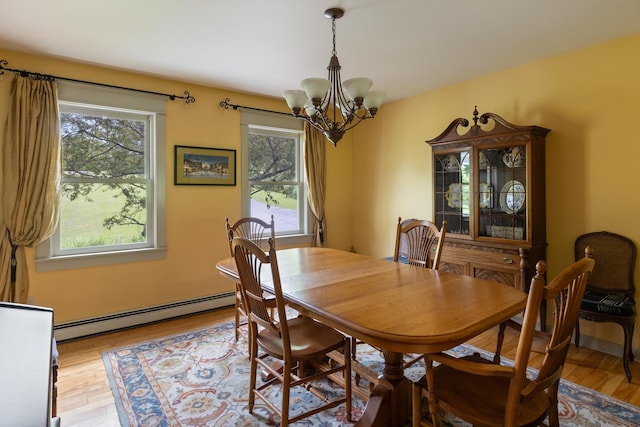 204 Mary Dr, Richmond, VT 05477 - dining space featuring baseboard heating, a chandelier, and light wood-style flooring