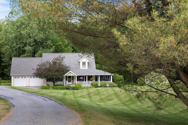 204 Mary Dr, Richmond, VT 05477 - new england style home featuring covered porch, driveway, a garage, a front lawn, and roof with shingles