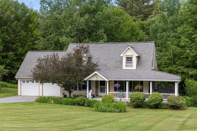 204 Mary Dr, Richmond, VT 05477 - view of front facade featuring driveway, a porch, a front lawn, a garage, and roof with shingles