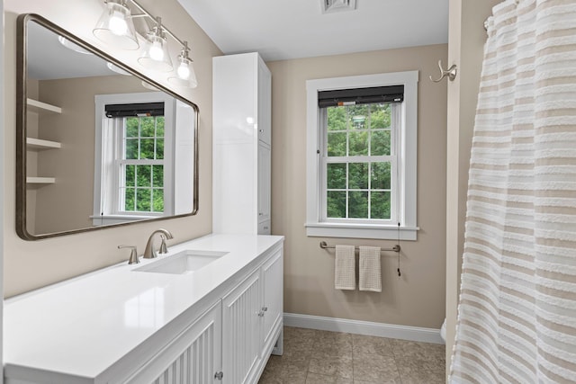 12 Cushman Way, Greenland, NH 03840 - bathroom with plenty of natural light, vanity, tile patterned flooring, and curtained shower