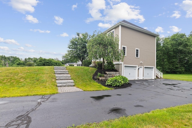 12 Cushman Way, Greenland, NH 03840 - view of side of property with stairs, an attached garage, driveway, and a yard
