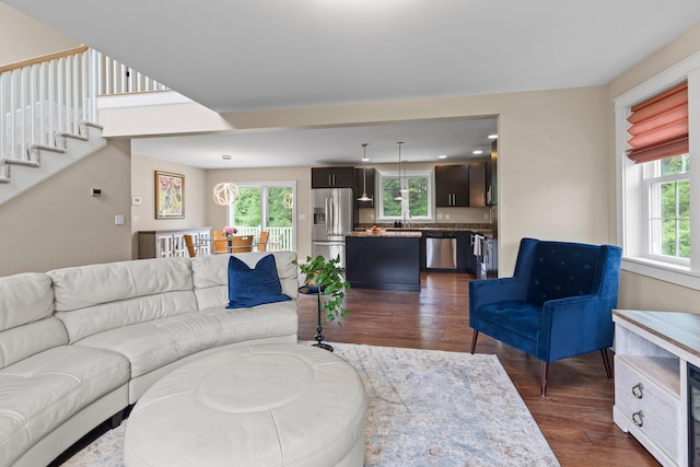 12 Cushman Way, Greenland, NH 03840 - living area featuring dark wood-style flooring and stairway