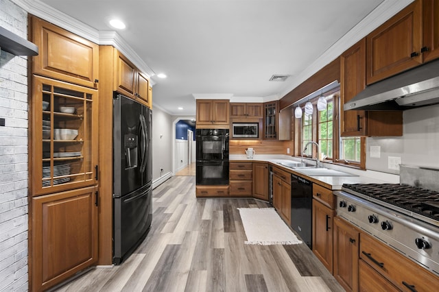 2 Ridgewood Dr, Kingston, NH 03848 - kitchen featuring black appliances, light wood-style floors, under cabinet range hood, light countertops, and brown cabinets