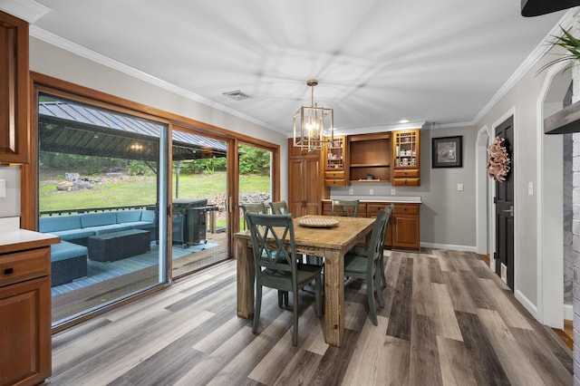 2 Ridgewood Dr, Kingston, NH 03848 - dining space with wood finished floors, a chandelier, and ornamental molding