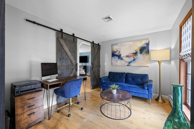 2 Ridgewood Dr, Kingston, NH 03848 - home office featuring a barn door, wood finished floors, and baseboard heating