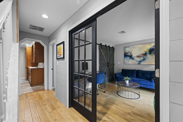 2 Ridgewood Dr, Kingston, NH 03848 - corridor featuring a barn door, wood finished floors, arched walkways, and recessed lighting
