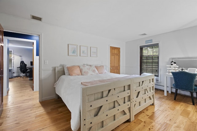 2 Ridgewood Dr, Kingston, NH 03848 - bedroom featuring an office area, light wood-style flooring, and a baseboard heating unit