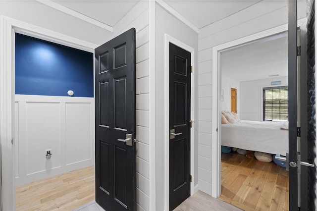 2 Ridgewood Dr, Kingston, NH 03848 - hallway featuring light wood-style flooring, a decorative wall, crown molding, and a wainscoted wall