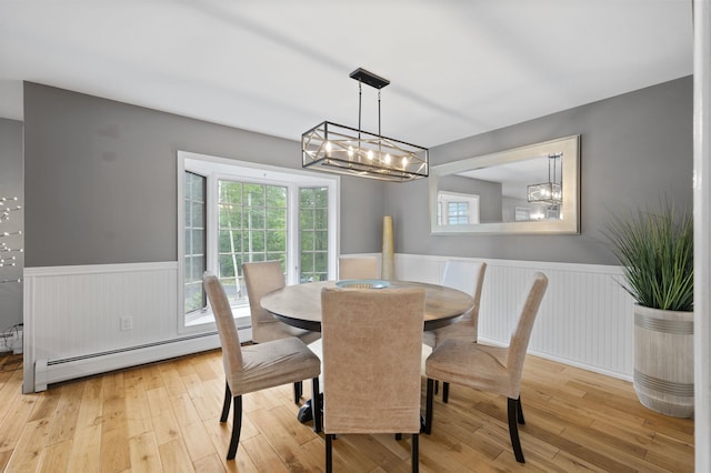 2 Ridgewood Dr, Kingston, NH 03848 - dining area featuring wainscoting, baseboard heating, light wood-style flooring, a chandelier, and plenty of natural light