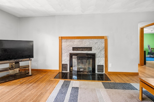 17 N Ave, Plaistow, NH 03865 - unfurnished living room with wood finished floors and a fireplace with flush hearth