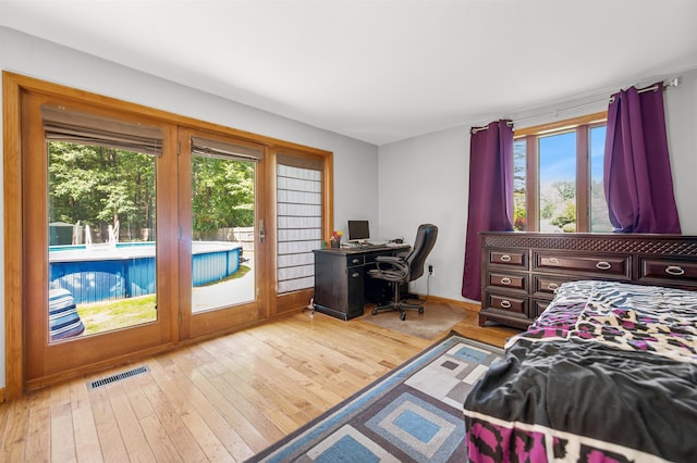 17 N Ave, Plaistow, NH 03865 - bedroom with access to outside, multiple windows, and hardwood / wood-style floors