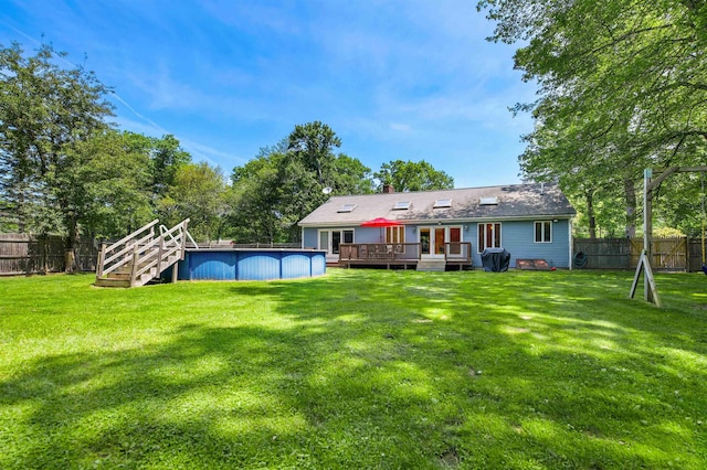 17 N Ave, Plaistow, NH 03865 - back of property with a deck, a fenced backyard, and a chimney