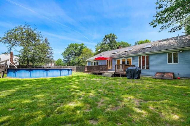 17 N Ave, Plaistow, NH 03865 - view of green lawn with a wooden deck and an outdoor pool