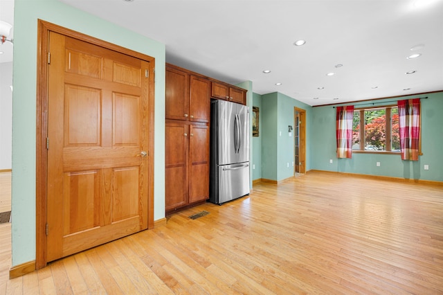 17 N Ave, Plaistow, NH 03865 - kitchen with freestanding refrigerator, light wood-style flooring, recessed lighting, and brown cabinets