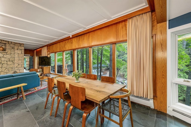679 Kearsarge Rd, Conway, NH 03860 - dining area featuring a baseboard heating unit, wooden walls, and dark stone finish flooring
