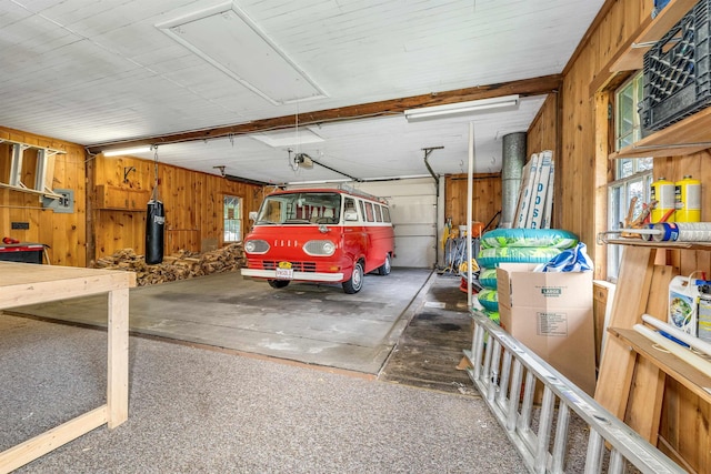 679 Kearsarge Rd, Conway, NH 03860 - garage featuring wooden walls and a garage door opener